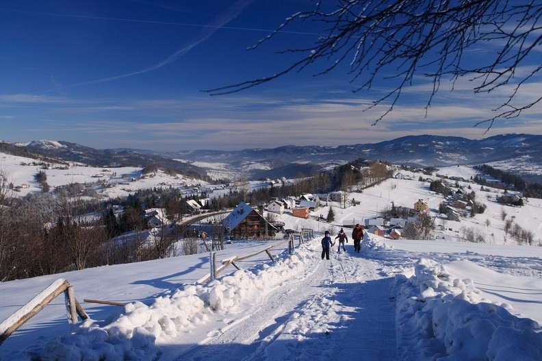 03-IMG 7528 -- Podejście na Ochodzitą / 2
W tle Koczy Zamek (nad głową Ines), z którego główny grzbiet karpacki obniża się w lewo, do Przełęczy Koniakowskiej;
z lewej widzimy zaśnieżone połacie Tynioka. W głębi, za przełęczą skupiły się domy Kamesznicy, ograniczone
od południa grzbietem Szarego. Całkiem po prawej, u góry ciemnieją Romanka i Rysianka z Lipowskim Wierchem